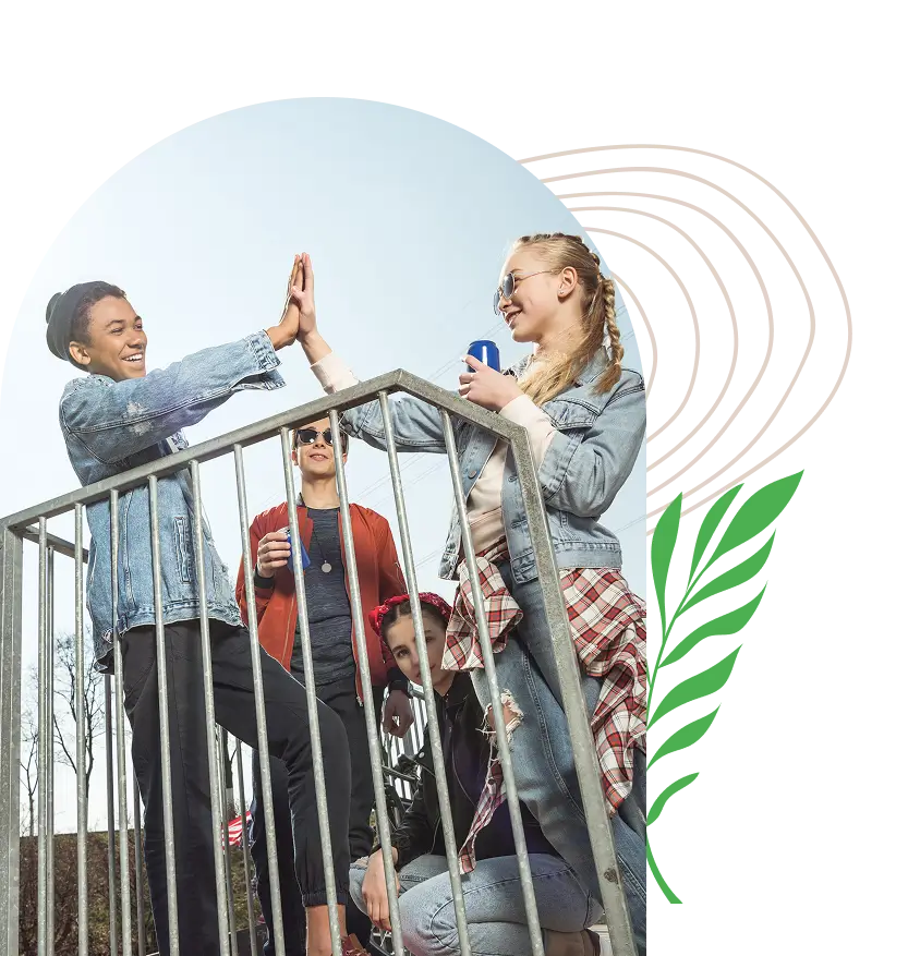 Group of friends enjoying and high-fiving on a sunny day.